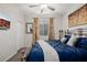 Cozy bedroom with decorative art, ceiling fan and a TV. Complete with a wrought iron bed and plush duvet at 864 Firestone Ledge Ave, Henderson, NV 89012