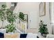 Bright entryway boasts soaring ceilings, neutral tile, and a staircase leading to the upper level with a fresh white banister at 864 Firestone Ledge Ave, Henderson, NV 89012
