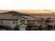 A residential street featuring multiple modern houses and a view of mountains in the distance at 864 Firestone Ledge Ave, Henderson, NV 89012