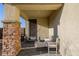 Welcoming front porch with stately pillars, stone accents, and comfortable seating, creating a grand arrival at 864 Firestone Ledge Ave, Henderson, NV 89012