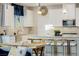 Stylish kitchen featuring white cabinets, a mosaic backsplash, granite counters, pendant lighting, and stainless steel appliances at 864 Firestone Ledge Ave, Henderson, NV 89012