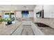 Bright kitchen featuring white cabinets, granite countertops, modern appliances, and an island at 864 Firestone Ledge Ave, Henderson, NV 89012