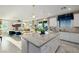 Open concept kitchen with island, granite countertops, white cabinets, and adjacent living area at 864 Firestone Ledge Ave, Henderson, NV 89012