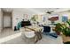 Bright open-concept living and dining area featuring modern decor, tile flooring, and a comfortable seating arrangement at 864 Firestone Ledge Ave, Henderson, NV 89012