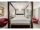 Main bedroom featuring a canopy bed, chandelier, bedside tables, and sitting chairs at 864 Firestone Ledge Ave, Henderson, NV 89012