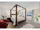 Spacious main bedroom with a luxurious canopy bed, side tables, and a sitting area at 864 Firestone Ledge Ave, Henderson, NV 89012