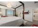 Main bedroom featuring a canopy bed, ensuite bathroom, laundry area, and city views at 864 Firestone Ledge Ave, Henderson, NV 89012