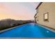 Backyard pool shimmers under a twilight sky, promising relaxation and recreation at 864 Firestone Ledge Ave, Henderson, NV 89012