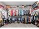 A fully organized walk-in closet featuring tiered shelving and hanging racks for clothes and accessories at 864 Firestone Ledge Ave, Henderson, NV 89012