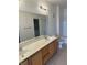 Bathroom vanity featuring laminate countertop, double sinks, and a large mirror at 8725 W Flamingo Rd # 226, Las Vegas, NV 89147