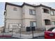 Low angle of the two story condo featuring multiple windows and exterior utility components and a red car in the parking lot at 8725 W Flamingo Rd # 226, Las Vegas, NV 89147