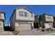 View of a charming two-story home with a two-car garage and simple desert landscaping at 8974 Lucky Crest St, Las Vegas, NV 89113