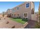 Backyard featuring desert landscaping and synthetic grass at 9853 Russian Hill St, Las Vegas, NV 89141