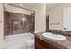 Bathroom featuring a shower-tub combo with stylish tiling and a dark vanity at 9853 Russian Hill St, Las Vegas, NV 89141
