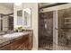 Modern bathroom with a glass-enclosed shower and marble countertops at 9853 Russian Hill St, Las Vegas, NV 89141