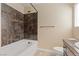 Bathroom featuring a shower-tub combo with stylish tiling and neutral walls at 9853 Russian Hill St, Las Vegas, NV 89141