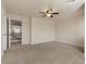 Generous bedroom features plush carpeting, a ceiling fan and view of the upper hallway at 9853 Russian Hill St, Las Vegas, NV 89141