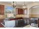 Gourmet kitchen with granite countertops, stainless steel appliances, and abundant natural light at 9853 Russian Hill St, Las Vegas, NV 89141