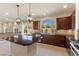Gourmet kitchen with dark wood cabinets, granite countertops, and stainless steel appliances at 9853 Russian Hill St, Las Vegas, NV 89141
