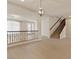 Inviting living area with an elegant chandelier, staircase, and wood floors at 9853 Russian Hill St, Las Vegas, NV 89141