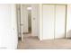 Neutral carpeted bedroom with bathroom entrance and closet at 1081 Pluto St, Pahrump, NV 89048
