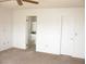 Bedroom featuring neutral carpet, a doorway to the bathroom, and a closet at 1081 Pluto St, Pahrump, NV 89048
