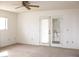 Bright bedroom with ceiling fan and double doors leading outside at 1081 Pluto St, Pahrump, NV 89048