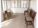 Bonus room with bright, natural light, featuring a wooden desk and several wooden chairs in the space at 1081 Pluto St, Pahrump, NV 89048