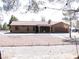 Inviting single-story house with tile roof, desert landscaping, and covered porch entrance at 1081 Pluto St, Pahrump, NV 89048
