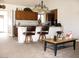 View of open kitchen with breakfast bar and light wood cabinetry, seamlessly connected to the living area at 1081 Pluto St, Pahrump, NV 89048