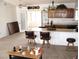 Inviting open kitchen featuring a breakfast bar and seamlessly flows into the living space with light from glass doors at 1081 Pluto St, Pahrump, NV 89048