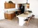 Bright kitchen featuring wooden cabinetry, tile flooring, black appliances, and a breakfast bar with seating at 1081 Pluto St, Pahrump, NV 89048