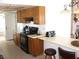 A functional kitchen with wood cabinets, black appliances, and ample counter space at 1081 Pluto St, Pahrump, NV 89048