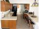 Well-lit kitchen featuring light countertops, wood cabinets, and tile floors at 1081 Pluto St, Pahrump, NV 89048