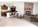 Open-concept living area with brick fireplace, kitchen bar, and comfortable seating, great for entertaining at 1081 Pluto St, Pahrump, NV 89048