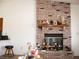 Cozy living room displaying a brick fireplace with a decorative mantel and various ornaments and decorations at 1081 Pluto St, Pahrump, NV 89048