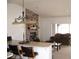 Cozy living area with a brick fireplace, complemented by bar stool seating at the kitchen counter at 1081 Pluto St, Pahrump, NV 89048