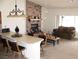 Cozy living room with brick fireplace, large windows, and breakfast bar with seating at 1081 Pluto St, Pahrump, NV 89048
