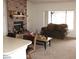 Living area features a decorative brick fireplace, couch and table at 1081 Pluto St, Pahrump, NV 89048