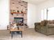 Comfortable living room with brick fireplace, mantle decor, and cozy seating area at 1081 Pluto St, Pahrump, NV 89048