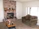 Living room featuring brick fireplace, bright window and cozy seating at 1081 Pluto St, Pahrump, NV 89048