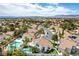 Wide aerial view showcasing homes featuring sparkling pools and lush desert landscaping at 1600 Windsford Cir, Las Vegas, NV 89117