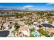 Picturesque aerial view showcasing community homes with pools and the distant mountains at 1600 Windsford Cir, Las Vegas, NV 89117