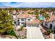 Aerial view of a home with a tile roof, desert landscaping, and a sparkling community pool at 1600 Windsford Cir, Las Vegas, NV 89117