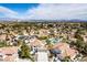 Expansive aerial view of a neighborhood showcasing lush landscaping and breathtaking mountain views at 1600 Windsford Cir, Las Vegas, NV 89117