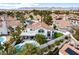 Aerial view featuring a patio, putting green, pool, and luscious landscaping at 1600 Windsford Cir, Las Vegas, NV 89117