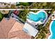 Aerial shot showcases backyard's freeform pool, spa, covered patio, and manicured landscaping, creating an outdoor retreat at 1600 Windsford Cir, Las Vegas, NV 89117