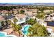 Bird's-eye view of a home with a swimming pool, patio area, desert landscaping and mountain views at 1600 Windsford Cir, Las Vegas, NV 89117