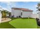 Beautiful backyard with lush green turf, putting green, and outdoor seating area perfect for entertaining at 1600 Windsford Cir, Las Vegas, NV 89117