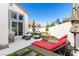 Inviting backyard with lounge chairs, dining area, and artificial grass for easy maintenance at 1600 Windsford Cir, Las Vegas, NV 89117